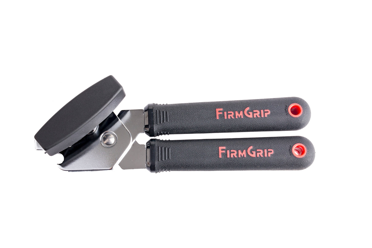 A black and silver FirmGrip Hand Can Opener with ergonomic black handles labeled FIRM GRIP in red text. The textured grips and stainless steel cutting wheel ensure comfort and durability, with holes at the ends, all shown against a white background.