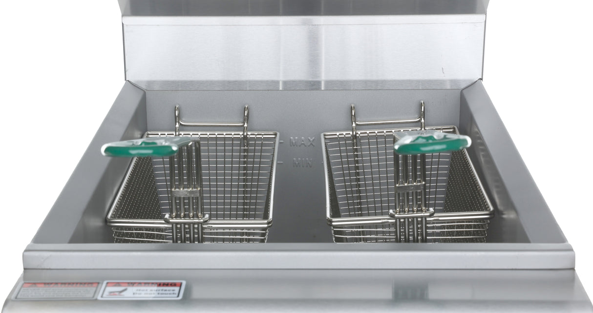 A close-up view of a stainless steel commercial electric fryer with two metal fry baskets, each with a green plastic-coated handle, positioned side by side inside the 40 lb capacity fryer. The background and surrounding surfaces are clean and reflective.