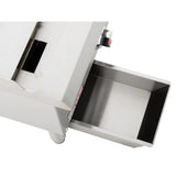 A close-up view of a heavy duty gas griddle with a stainless steel finish and a pull-out rectangular tray. The tray is partially open, revealing a smooth metallic interior. A control knob and slot are set above it, all against a plain white background.