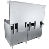 A large, industrial stainless steel dishwasher with an open lid, revealing internal compartments, stands beside a double base gas range. Sturdy legs support the boxy design—perfect for heavy-duty commercial kitchen use.