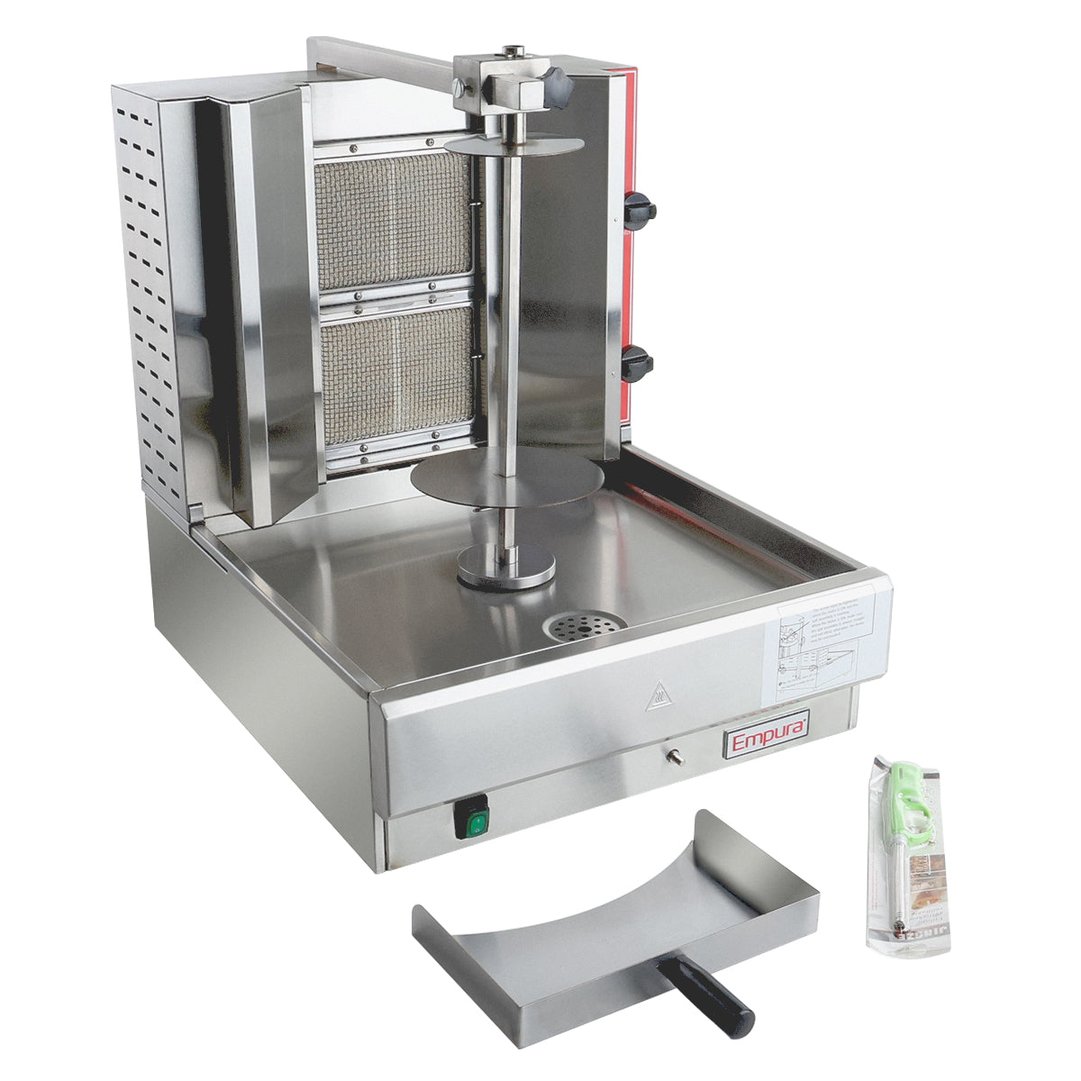 A stainless steel gas vertical broiler for shawarma or gyro, featuring a central spit, rear heating panels, drip tray at the bottom, side handles, and labeled controls. A metal drip tray and an accessories packet are also shown on the right.