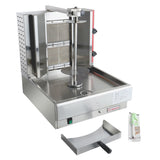A stainless steel gas vertical broiler for shawarma or gyro, featuring a central spit, rear heating panels, drip tray at the bottom, side handles, and labeled controls. A metal drip tray and an accessories packet are also shown on the right.