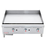 The Empura EMG-36 is a Heavy Duty Gas Griddle featuring a stainless steel flat-top, three control knobs with red markers, sturdy legs, and raised edges. This countertop gas griddle displays the Empura brand on the lower left corner.