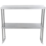 A stainless steel table with a smooth rectangular top, four cylindrical legs, and a flat lower shelf for additional storage. Its industrial, minimalist design can be enhanced with an optional table-mounted overshelf for even more organization.