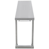 A front view of a long, rectangular stainless steel table with a flat top, four cylindrical metal legs, and a support bar near the base. The simple, industrial design is suitable for kitchens or workspaces and can accommodate a table-mounted overshelf.