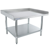 A stainless steel NSF work table with a raised edge on three sides, a flat work surface, a lower storage shelf, round legs, and adjustable feet. The front features an Empura logo. The table is clean and industrial in design.