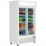 A white, glass-door commercial refrigerated merchandiser displays shelves stocked with various drinks, including sodas and energy drinks. This foodservice equipment features two sliding doors, temperature control, a blank top sign, and wheels.