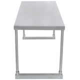 A front view of a stainless steel table with a flat, smooth top and four cylindrical legs. The sturdy, industrial design features metal support bars at the base, while the polished surface reflects light for a clean look—ideal for adding an overshelf.