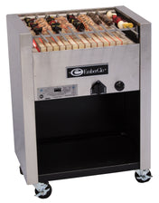 A stainless steel Kabob Charbroiler EmberGlo grill with skewers of meat and vegetables on a ceramic hearth, featuring a control knob and vents on the front, stands on four caster wheels with open storage below. Operates on natural gas.