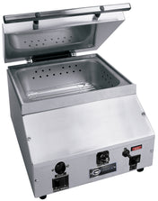 A stainless steel countertop steamer with an open hinged lid reveals a perforated metal insert inside. The front panel features control knobs, switches, indicator lights, and a brand logo labeled Epicure. Direct water hookup for convenience.
