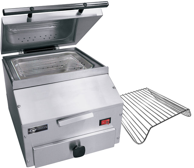 A stainless steel countertop food warmer with a hinged lid propped open, exposing a metal interior with a grill rack inside. A second, removable grill rack is placed beside the unit. The front features a handle, knob, and red power switch.