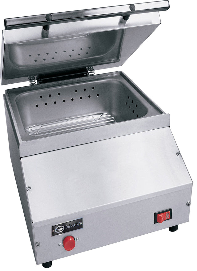 A stainless steel countertop steamer with a hinged lid open, revealing a perforated removable tray. The front panel features a red button, power switch, brand label, and angled edges. Designed for commercial use with an optional direct water hookup.