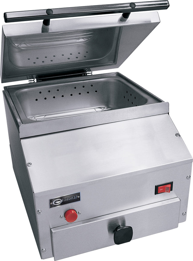 A stainless steel countertop steamer with a hinged lid open reveals a perforated steam tray inside. The front features a red power switch, indicator light, control knob, and manufacturer label. The self-contained steamer is clean and empty.