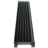 A black, rectangular plastic object with six deep, evenly spaced grooves runs lengthwise. Viewed from one end, its raised ridges and flat base resemble a cooking grate or component used in charbroilers, likely for industrial or kitchen use.