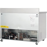 A commercial Empura E-KUC48W work top refrigerator with a metal exterior, vented lower section revealing internal coils and wiring, warning label “C5H10,” and wheels for mobility. The upper silver panel displays various labels and information stickers.