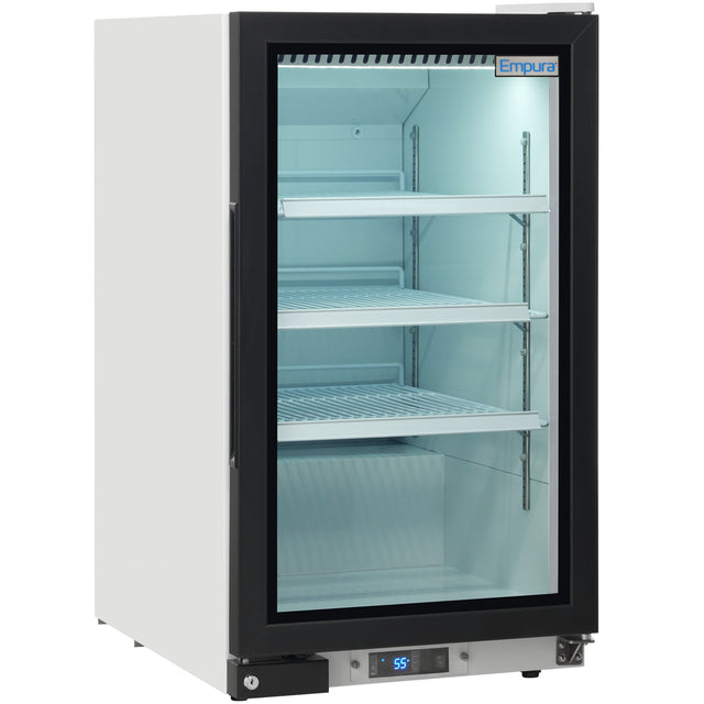 A commercial glass-door refrigerator, perfect as a countertop merchandiser, features a black frame, three adjustable wire shelves, white interior, and LED lighting. The digital temperature display shows 55°F. Empura branding is on the door.