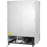 A large, industrial silver metal commercial freezer on wheels with two closed doors. The lower front panel is open, exposing mechanical components and wiring inside. A yellow caution sign with a chemical symbol is visible near the bottom left.