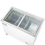 An Empura white commercial freezer with two wire baskets and a sliding glass lid, viewed from above. The metallic interior is empty, and the control panel is visible on the lower right side of the chest freezer.