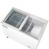 An Empura chest freezer features two sliding glass lids partially open, revealing spacious wire baskets inside. This commercial freezer has a control panel on the lower front edge and an empty, clean metallic interior.