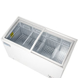 A top-down view of a commercial chest freezer with two sliding glass doors, revealing three separate compartments with white wire baskets inside. The freezer is clean and empty, set against a plain white background.