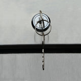 A close-up of a metal key inserted into a circular lock on a brushed stainless steel surface, likely belonging to an Empura Refrigeration reach-in refrigerator or commercial refrigerator cabinet. The key is attached to a simple round keyring.