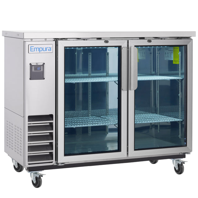 A commercial refrigerator on wheels with two glass doors, metal shelves, and a digital temperature display. The Empura brand is visible on the top left. This empty, well-lit glass door cooler is ideal for showcasing chilled products.