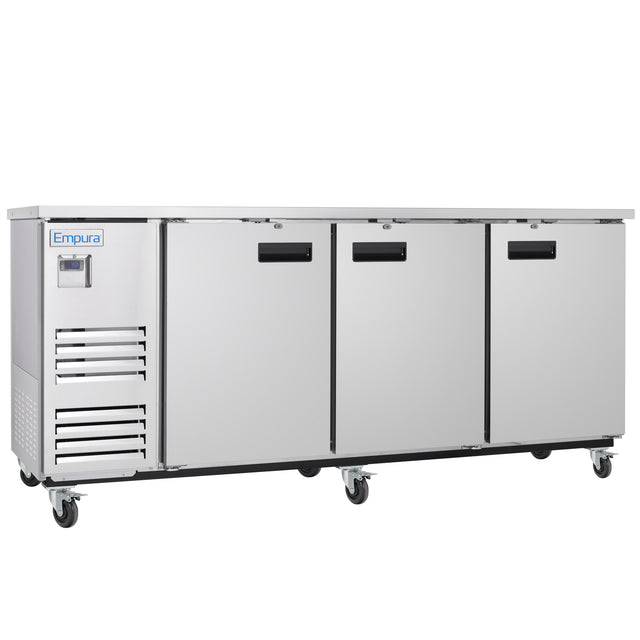 A commercial Empura Refrigeration stainless steel back bar cooler with three doors and black handles, mounted on six wheels. It features a digital control panel on the left, ventilation slats below, and the brand name Empura on the top left corner.