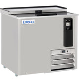 The Empura Refrigeration stainless steel bottle cooler features a sliding lid, built-in bottle opener, cap catcher, ventilation grates, and a control panel. Branded “Empura” on the front, it stands on small wheels for easy mobility.