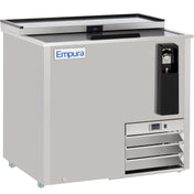 The Empura Refrigeration stainless steel bottle cooler features a sliding lid, built-in bottle opener, cap catcher, ventilation grates, and a control panel. Branded “Empura” on the front, it stands on small wheels for easy mobility.
