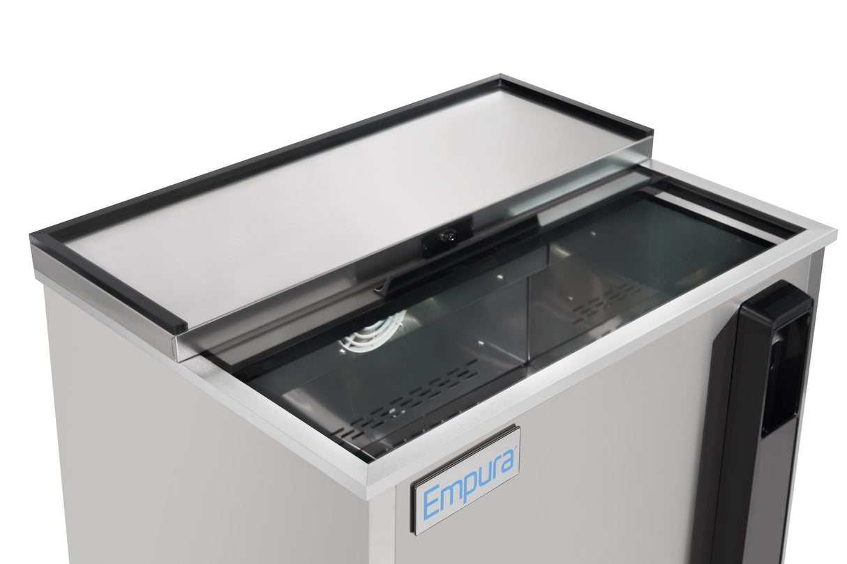A stainless steel bottle cooler or commercial refrigerator with a sliding glass lid, partially open to reveal an empty interior. The front features the Empura refrigeration brand on a blue and white label. The appliance is clean and modern.