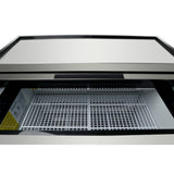 A close-up view of an empty commercial freezer with a glass top. The inside features white metal wire shelving, and there is a product information label along the interior wall. This glass door freezer is clean and well-lit.