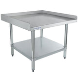 A sturdy, industrial equipment stand with a stainless steel top shelf, four cylindrical legs, and a raised edge on three sides. The lower shelf adds extra storage. NSF certified for commercial kitchen use. Brand label Empura is visible.