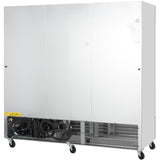 A large, stainless steel industrial cabinet stands on four wheels. Its lower front panel is open, revealing wiring and pipes. The upper section has smooth, reflective doors with small labels—typical of an Empura Refrigeration reach-in freezer.