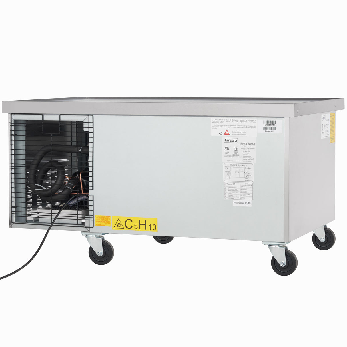 A rectangular stainless steel refrigerated stand with metal sides and four swivel caster wheels. The left side features an exposed compressor, a “C5H10” flammable gas warning label, and multiple instruction stickers—ideal Empura refrigeration for commercial use.