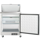 A commercial stainless steel Empura Refrigeration sandwich prep table with its top lid open and front door ajar, revealing an interior shelf and ventilated panel. The textured, white inner door surface and four wheels enhance mobility and functionality.