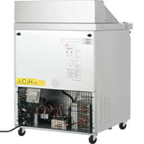 A commercial Empura Refrigeration unit on wheels, shown from the back. The lower section is open, revealing cooling components and a fan behind a metal grill. A yellow C5H10 warning label is visible—ideal as a Refrigerated Sandwich Prep Table.