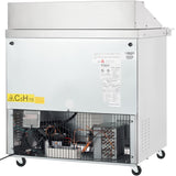 A commercial Empura refrigeration unit on wheels with a metal exterior. Labels and safety warnings are visible, including a yellow “C5H10” sticker. The lower section shows electrical components behind a vented grille, like a salad mega top prep table.