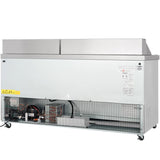 A commercial refrigeration unit with a white front panel, ventilation grilles, exposed coils and wiring at the base. The NSF-7 certified appliance features wheels for mobility, a caution label on the left, and a technical specification label on the right.