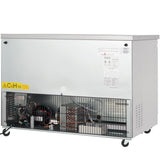 A large, metallic Empura E-KUC48F commercial freezer on wheels with an exposed lower section revealing wiring, compressor, and cooling components. The upper part is plain, featuring warning labels, technical stickers, and ventilation holes on the right side.