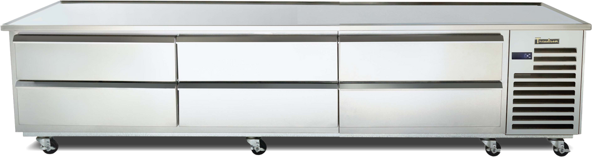 A large, stainless steel refrigerated equipment stand with six pull-out drawers and vented panels on the right side, set on four lockable caster wheels. Its flat surface doubles as a countertop and offers high pan capacity for busy professional kitchens.