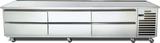 A large, stainless steel refrigerated equipment stand with six pull-out drawers and vented panels on the right side, set on four lockable caster wheels. Its flat surface doubles as a countertop and offers high pan capacity for busy professional kitchens.