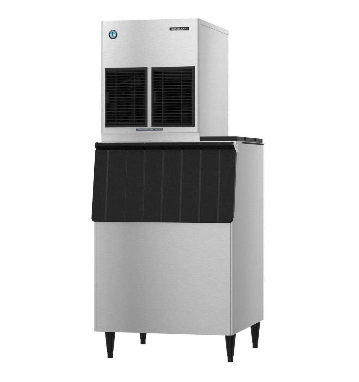 A high production ice machine with a stainless steel body, black front panel, and four legs. The top unit has two black vents, while the lower ice storage bin features a slanted, textured black door for an industrial and modern look.