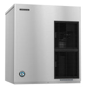 A stainless steel Hoshizaki ice maker with a sleek, boxy design. It features a vent with black horizontal slats on the right and two brand badges on the upper left and lower left corners. This air-cooled ice maker delivers efficient performance.
