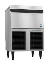 A commercial stainless steel ice maker with a large top bin, black handle, side vents, and four sturdy legs. The front features two black grated panels and a small blue certification sticker. Its industrial design efficiently produces cubelet ice.
