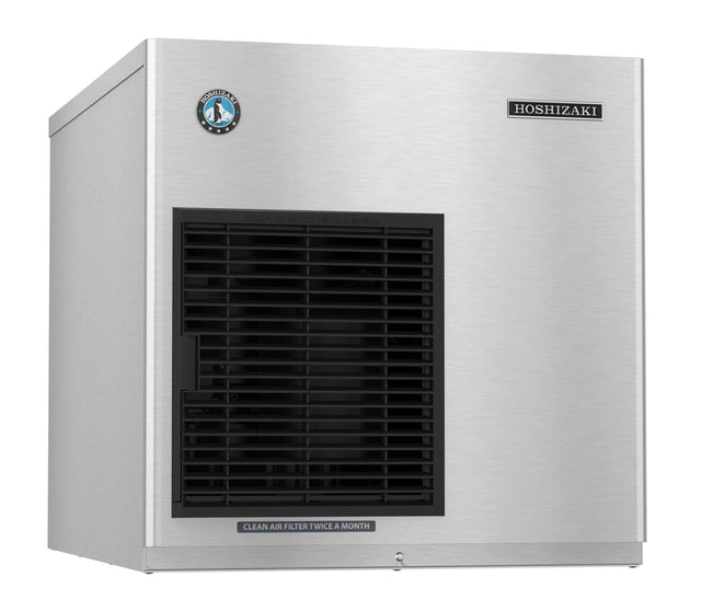 A stainless steel Hoshizaki ice maker with a rectangular shape, black front-left vent, and brand logos at the top corners. A label below the vent reads, “CLEAN AIR FILTER TWICE A MONTH.” This cubelet-style unit is set against a plain white background.