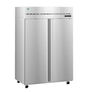 A large, stainless steel, double-door reach-in commercial refrigerator stands on four small wheels. The fridge features a vented panel above the doors, a digital temperature display on the right, and long vertical handles down each center.