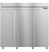 A large, stainless steel commercial freezer with three vertical doors, vent slots at the top, a digital control panel on the upper right, and wheels at the bottom for mobility. The sleek exterior gives this reach-in freezer an industrial look.