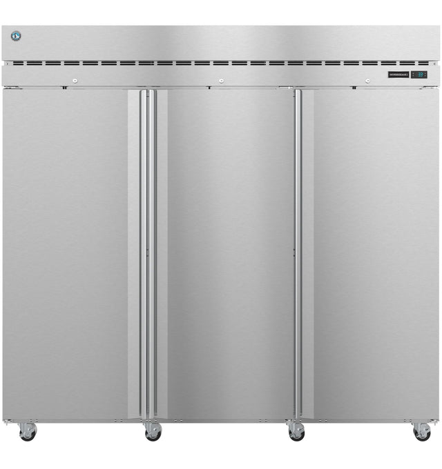 A large, stainless steel commercial freezer with three vertical doors, vent slots at the top, a digital control panel on the upper right, and wheels at the bottom for mobility. The sleek exterior gives this reach-in freezer an industrial look.