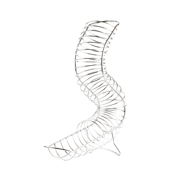 A silver metal slinky toy is twisted into an upright, curving S-shaped spiral, resembling a chrome plated fruit basket, against a plain white background. The stretched coils form a dynamic and abstract sculptural shape.