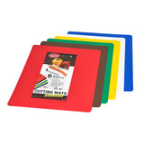 Five flexible cutting mats are stacked, each in a different color: red, brown, green, yellow, white, and blue. The top mat’s label highlights vegetables and notes this set of six color-coded, dishwasher safe cutting mats for food safety.